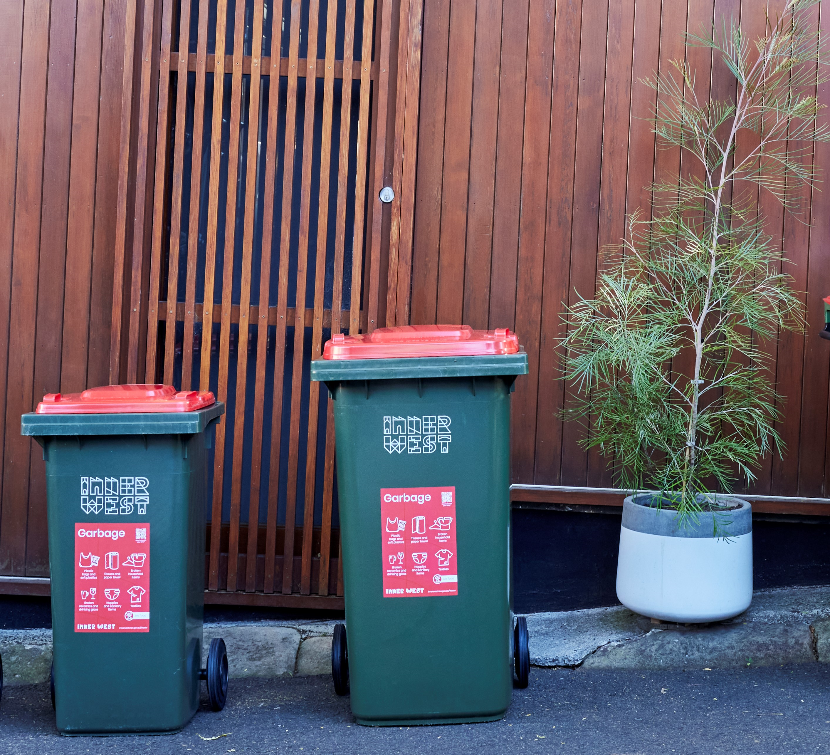 Two red bins on the street
